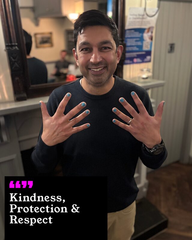 Abid David holding up his painted nails. His three words: Kindness, Protection and Respect.