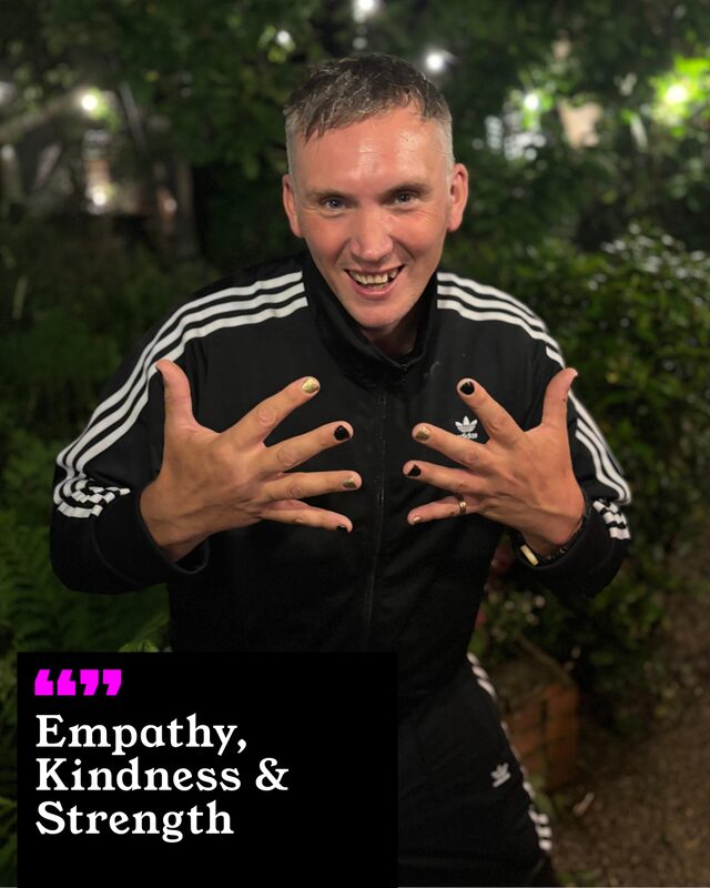 Benjamin Perkins holding up his painted nails. His three words: Empathy, Kindness and Strength.