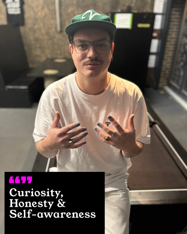 Chris Tanner holding up his painted nails. His three words: Curiosity, Honesty and Self-awareness.