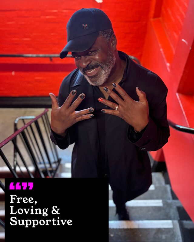 Danny Sapani holding up his painted nails. His three words: Free, Loving and Supportive.