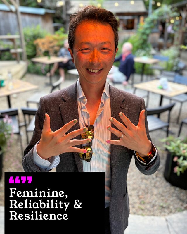 Eddie Cheng holding up his painted nails. His three words: Feminine, Reliability and Resilience.