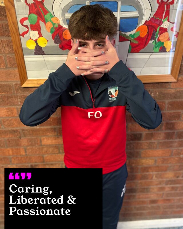 Finlay O'Connor holding up his painted nails. His three words: Caring, Liberated and Passionate.