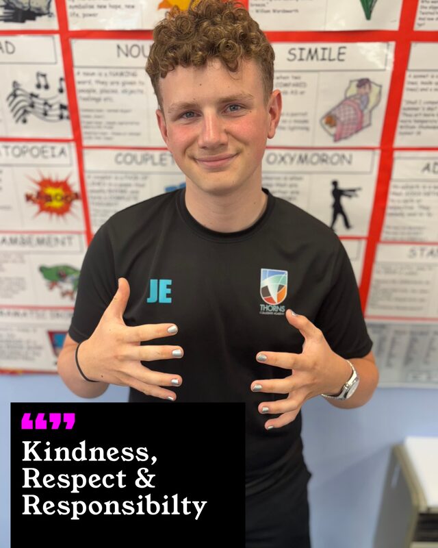 Jack Etherington holding up his painted nails. His three words: Kindness, Respect and Responsibility.
