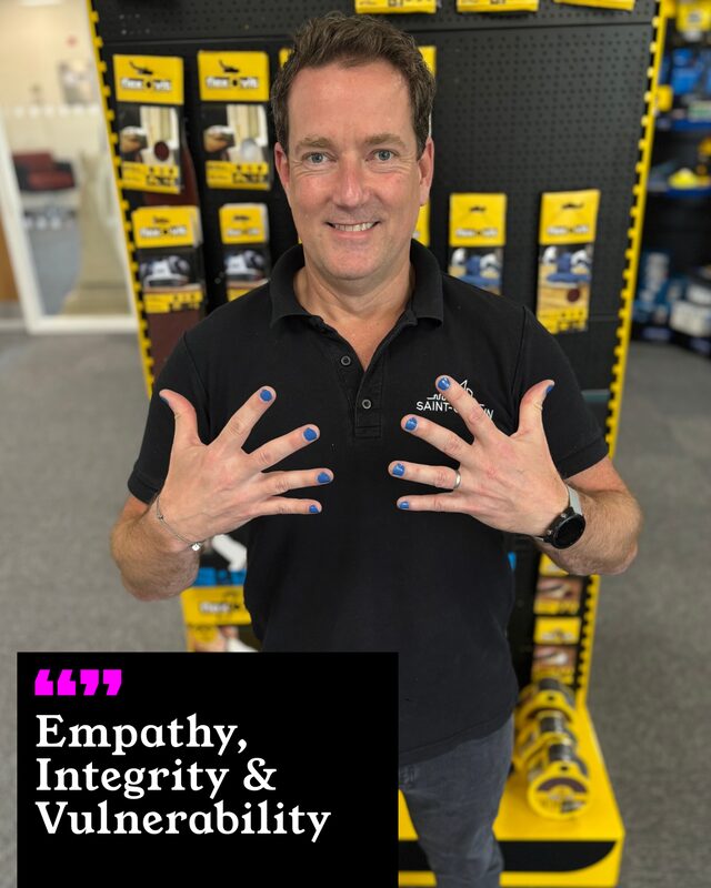 James holding up his painted nails. His three words: Empathy, Integrity and Vulnerability.