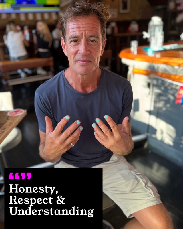 Johnny Rayner holding up his painted nails. His three words: Honesty, Respect and Understanding.