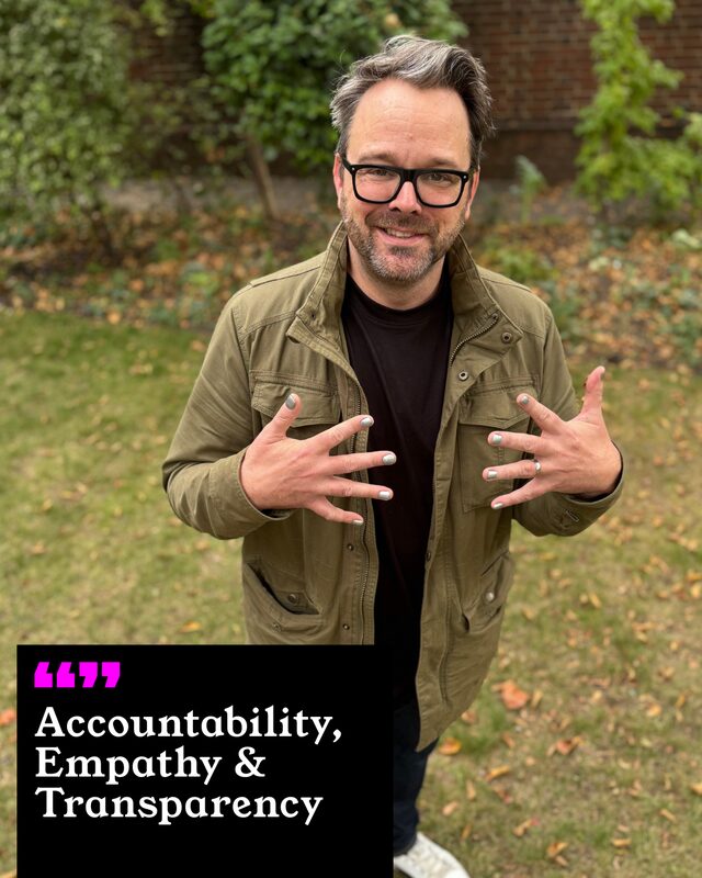Justin North holding up his painted nails. His three words: Accountability, Empathy and Transparency.
