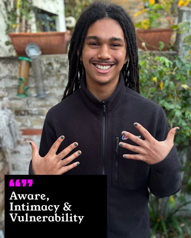 Khanya Nzuza holding up his painted nails. His three words: Aware, Intimacy and Vulnerability.
