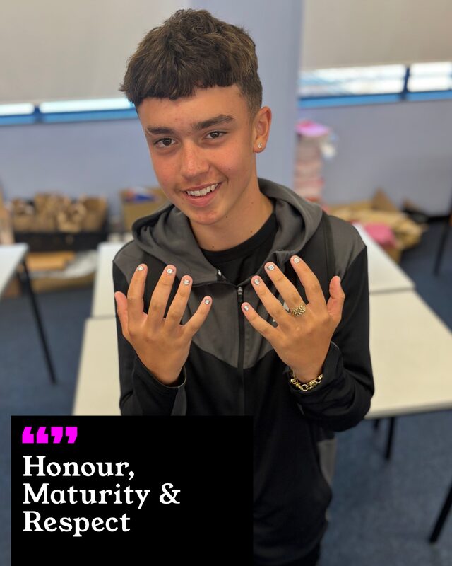 Kyah Mcneil holding up his painted nails. His three words: Honour, Maturity and Respect.