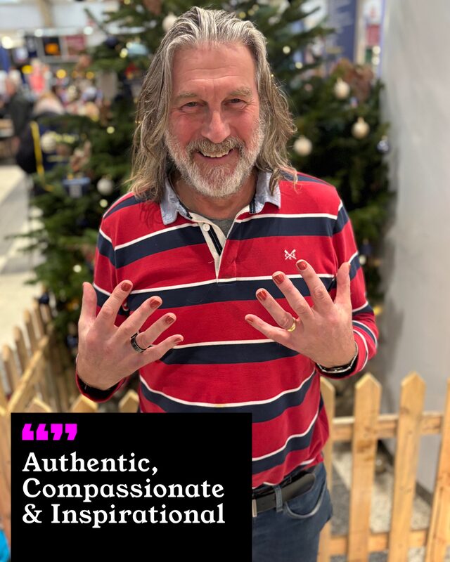 Mark Newey holding up his painted nails. His three words: Authentic, Compassionate and Inspirational.