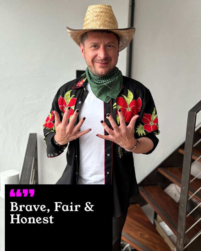 Matt Craddock holding up his painted nails. His three words: Brave, Fair and Honest.