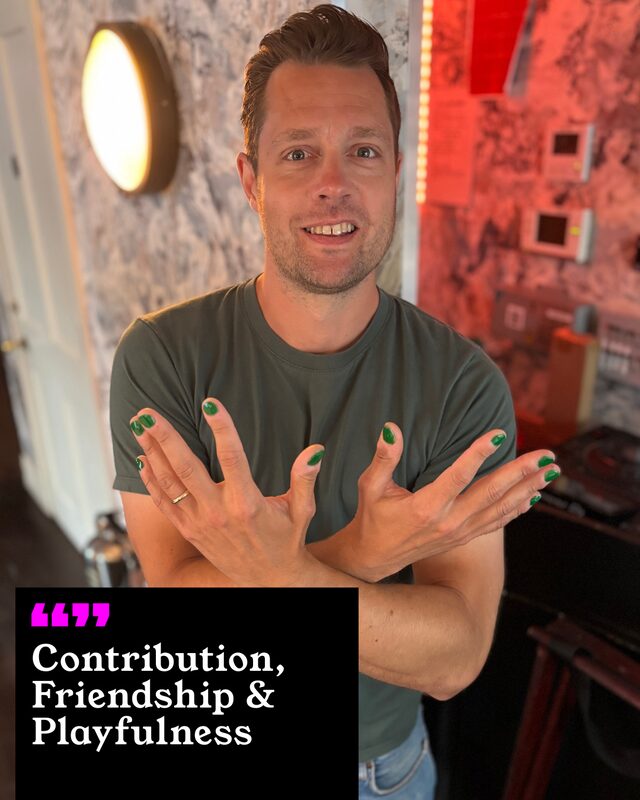 Max Dickins holding up his painted nails. His three words: Contribution, Friendship and Playfulness.