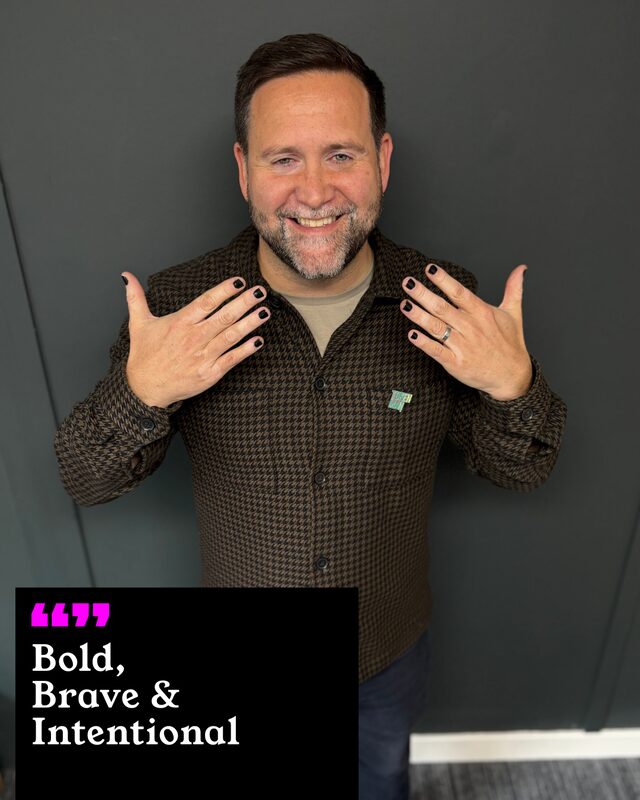 Neil Poulter holding up his painted nails. His three words: Bold, Brave and Intentional.