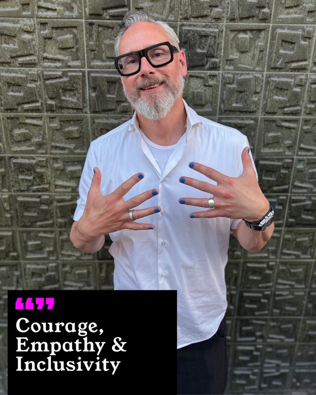Nick Blunden holding up his painted nails. His three words: Courage, Empathy and Inclusivity.