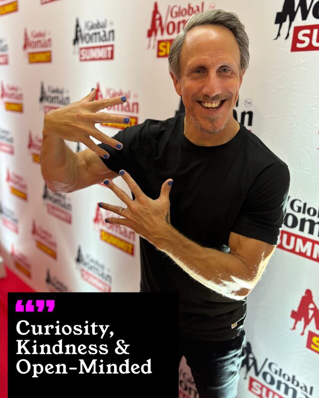 Nick Feeney holding up his painted nails. His three words: Curiosity, Kindness and Open-minded.