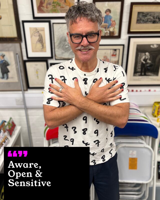 Paul Greatbatch holding up his painted nails. His three words: Aware, Open and Sensitive.