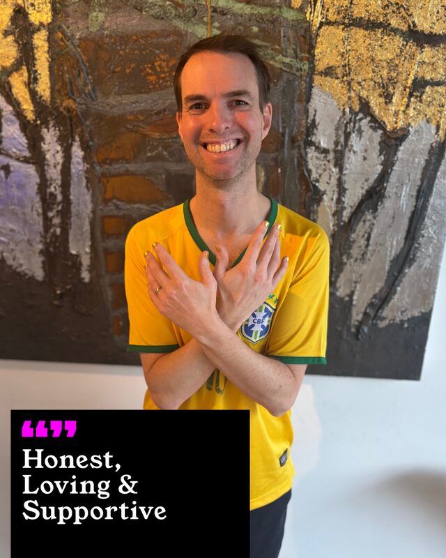 Paul Lambert holding up his painted nails. His three words: Honest, Loving and Supportive.