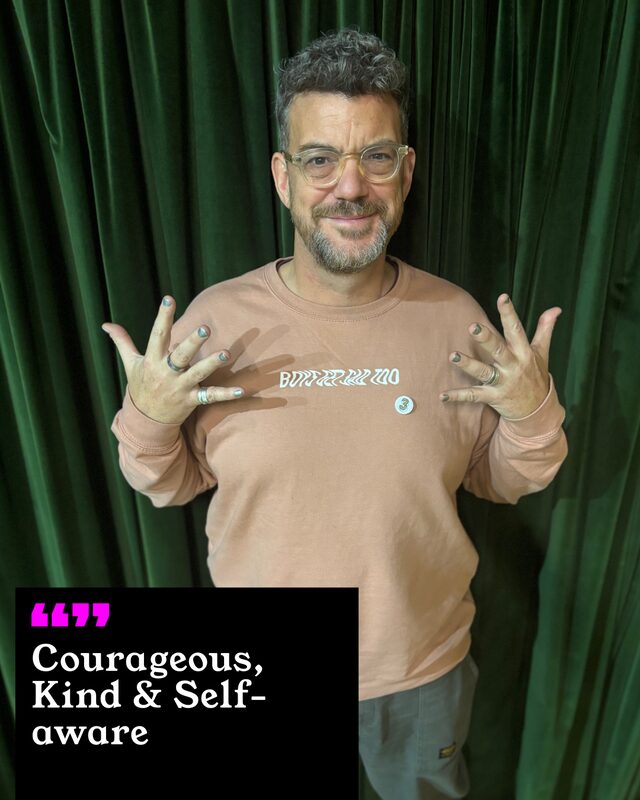 Phil Bartlett holding up his painted nails. His three words: Courageous, Kind and Self-aware.