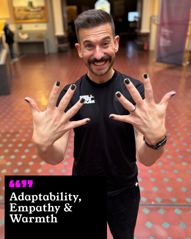 Richard Loftus holding up his painted nails. His three words: Adaptability, Empathy and Warmth.