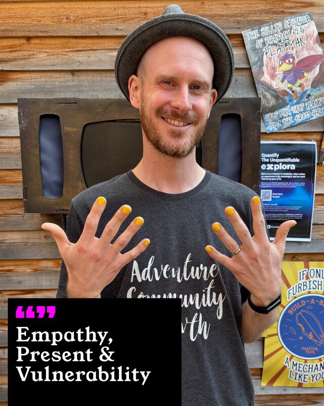 A participant holding up his painted nails. His three words: Empathy, Present and Vulnerability.