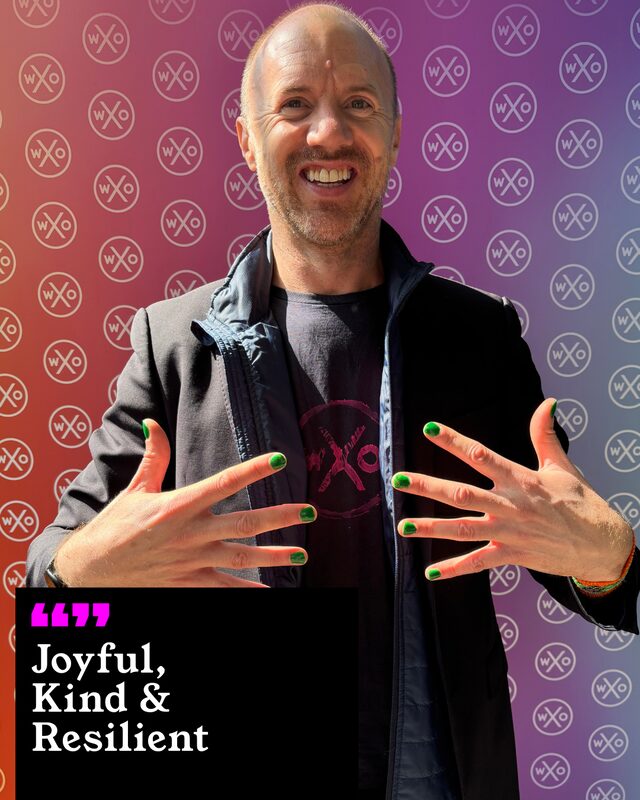A participant holding up his painted nails. His three words: Joyful, Kind and Resilient.