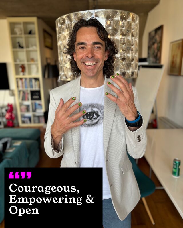 A participant holding up his painted nails. His three words: Courageous, Empowering and Open.