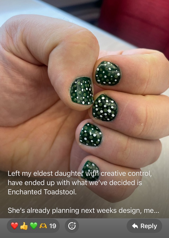 A hand with dark green nails covered in white and olive dots. The participant wrote: Left my eldest daughter with creative control, have ended up with what we&rsquo;ve decided is Enchanted Toadstool