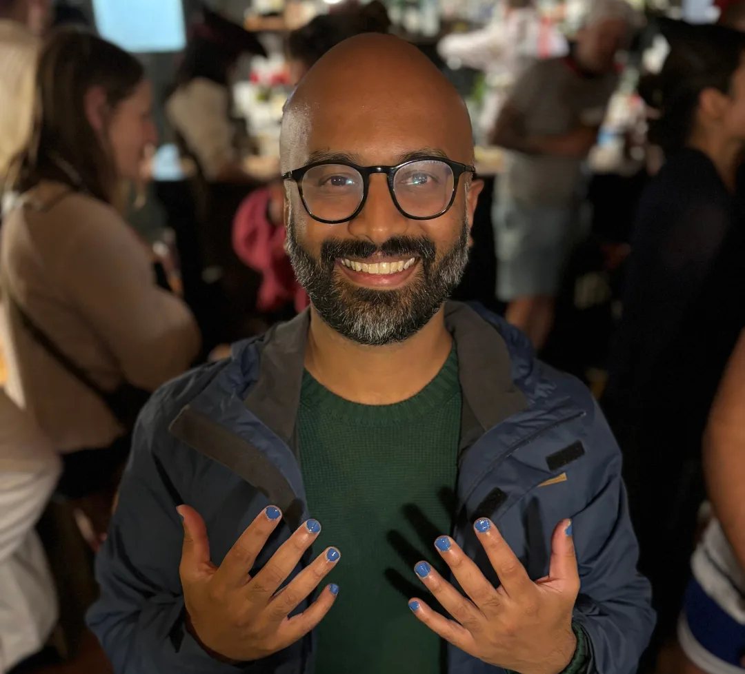 Sanj Ambalavanar holding up his painted nails